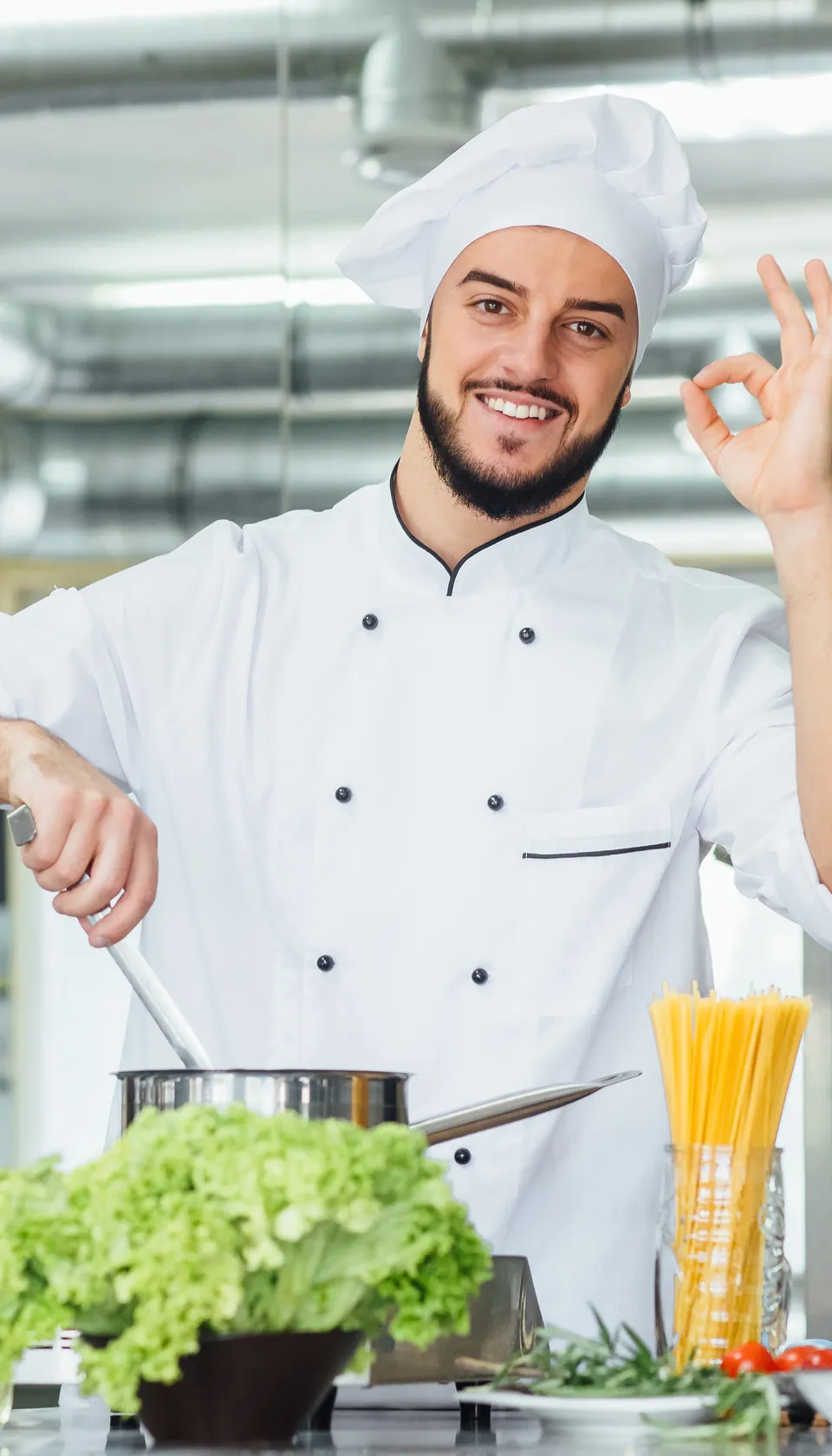 Chef cuisinier souriant en toque préparant un plat